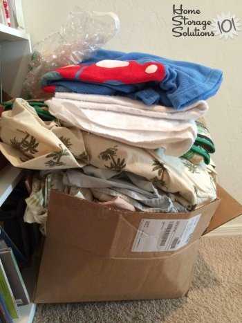 Box of bedding clutter that will be donated to a woman's shelter {part of the Declutter 365 mission to declutter blankets, on Home Storage Solutions 101}