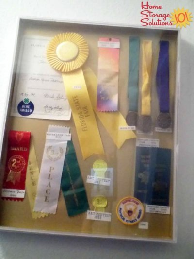 Display the ribbons, medals, trophies and other awards that you receive, or get rid of them if you have too much to actually enjoy and be proud of {#Declutter365 mission on Home Storage Solutions 101} 