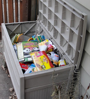 Large home recycling bin behind house