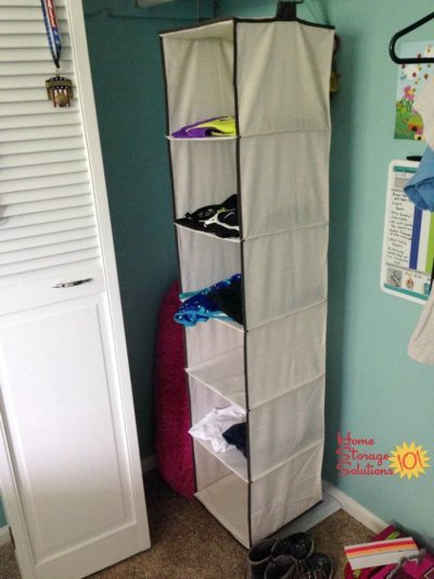 Hanging closet organizer used to lay out 6 days worth of clothes, socks and accessories to make mornings less stressful {featured on Home Storage Solutions 101}