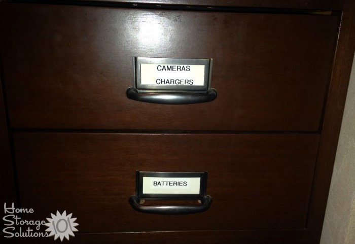 Labeled drawer for cameras and chargers, and another for batteries {on Home Storage Solutions 101}