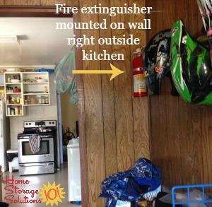 fire extinguisher placement by kitchen