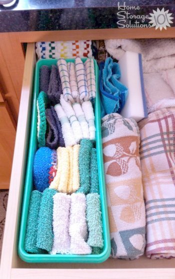 Separate certain kitchen towels from others, such as dish towels from hand towels, inside a kitchen drawer by using a shallow basket or storage container {featured on Home Storage Solutions 101}