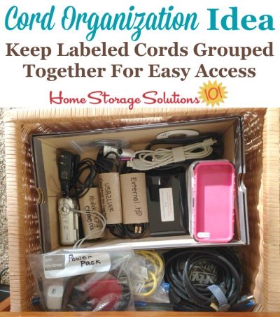 Organized cord storage drawer, with cables and cords labeled and separated so they don't tangle {featured on Home Storage Solutions 101}