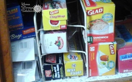 Store aluminum foil and kitchen wrap boxes in a simple rack in the pantry {featured on Home Storage Solutions 101}