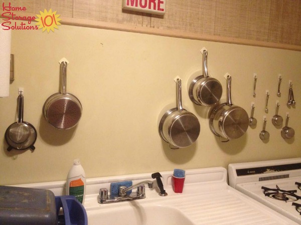 If you don't have much cabinet space you can hang your pots and pans on your kitchen wall {featured on Home Storage Solutions 101}