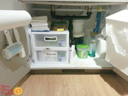 Add storage space under your kitchen sink by adding hooks for cleaning tools or whatever else you need to store there {featured on Home Storage Solutions 101}
