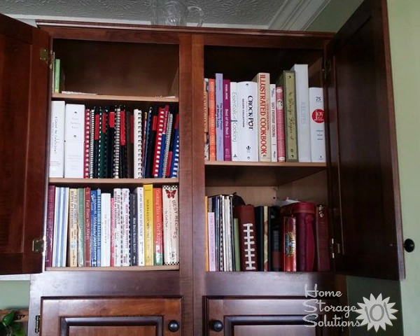 Organizing cookbooks inside kitchen cabinets {featured on Home Storage Solutions 101}