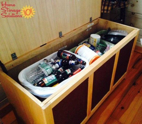 Recycling hidden within a storage bench in kitchen {featured on Home Storage Solutions 101}