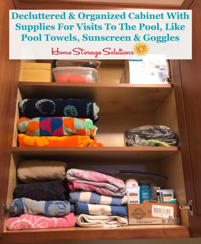 Decluttered and organized cabinet holding stuff for pool visits {on Home Storage Solutions 101}