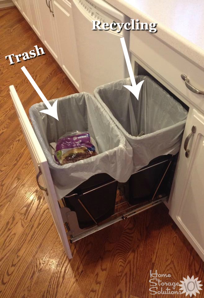 Example of a pull out trash can inside kitchen cabinets, where you can have both a can for trash and another for recycling {featured on Home Storage Solutions 101}