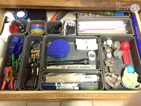 Organized junk drawer using modular drawer dividers, featured on Home Storage Solutions 101