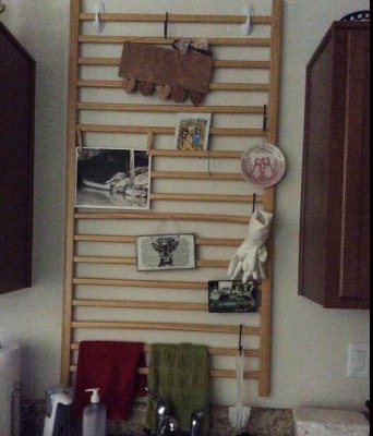 used baby crib rail hung in kitchen