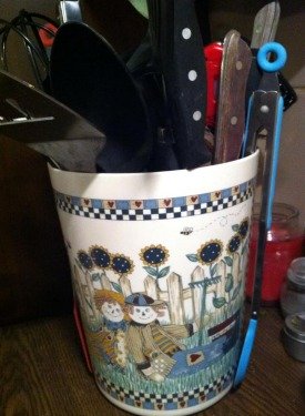 utensils held in unused small kitchen trash can
