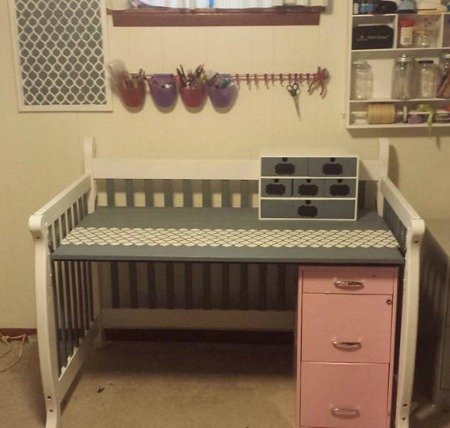repurpose used baby crib into a desk
