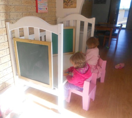 upcycle a used baby crib into a kids activity center