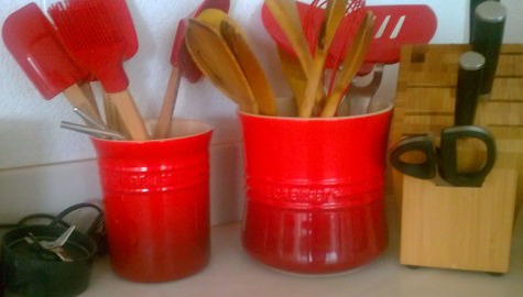 red Le Creuset utensil crocks